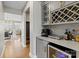 Butler's pantry features gray cabinetry, wine refrigerator, counter space, and convenient wine storage at 12205 Hollinhope Dr, Charlotte, NC 28278