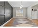Dining room featuring modern lighting, hardwood floors, and a stylish accent wall at 12205 Hollinhope Dr, Charlotte, NC 28278