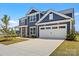 Well-maintained two-story home featuring a two-car garage and beautifully landscaped front yard at 12205 Hollinhope Dr, Charlotte, NC 28278
