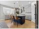 Modern kitchen with stainless steel appliances, island with seating, and hardwood floors at 12205 Hollinhope Dr, Charlotte, NC 28278
