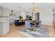 Modern kitchen with stainless steel appliances, a large island, and an adjacent dining area with stylish chandelier at 12205 Hollinhope Dr, Charlotte, NC 28278