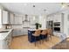 Open kitchen with island seating, stainless appliances, and designer finishes at 12205 Hollinhope Dr, Charlotte, NC 28278