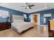 Main bedroom featuring tray ceiling, ensuite bath and neutral bedding at 12205 Hollinhope Dr, Charlotte, NC 28278