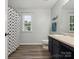 Neutral toned bathroom with a sink, vanity, toilet, and shower with a patterned curtain at 13314 Pontchatrain Ave, Charlotte, NC 28273
