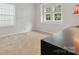Bright and open bedroom features two windows providing natural light and neutral colored carpet at 13314 Pontchatrain Ave, Charlotte, NC 28273