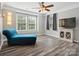 Bright bedroom with windows, modern ceiling fan, and chaise lounge at 13314 Pontchatrain Ave, Charlotte, NC 28273