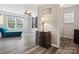 Bright bedroom with natural light, chaise lounge, modern ceiling fan, and wood laminate flooring at 13314 Pontchatrain Ave, Charlotte, NC 28273
