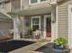 Charming front porch with seating and decorative accents, creating a welcoming entrance at 13314 Pontchatrain Ave, Charlotte, NC 28273