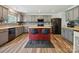 Open kitchen featuring stainless steel appliances, gray cabinetry, kitchen island with breakfast bar seating at 13314 Pontchatrain Ave, Charlotte, NC 28273