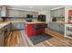 Bright kitchen featuring stainless steel appliances, gray cabinetry, and a kitchen island with breakfast bar seating at 13314 Pontchatrain Ave, Charlotte, NC 28273