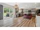 Modern kitchen featuring gray cabinets, an island with seating, and a sliding glass door at 13314 Pontchatrain Ave, Charlotte, NC 28273