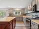 Open kitchen featuring stainless steel appliances, gray cabinetry, and a spacious center island at 13314 Pontchatrain Ave, Charlotte, NC 28273