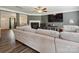 Cozy living room featuring a fireplace, a large television, and wood floors at 13314 Pontchatrain Ave, Charlotte, NC 28273