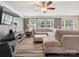Spacious living room with a large sectional sofa, TV, and natural lighting at 13314 Pontchatrain Ave, Charlotte, NC 28273