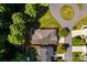 Overhead view of a brick home and its property with a red boundary outline; surrounded by lush greenery at 141 Aberdeen Dr, Troutman, NC 28166
