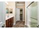Bathroom featuring wooden vanity, tile floors, mirror, open door to closet, and enclosed glass shower at 141 Aberdeen Dr, Troutman, NC 28166