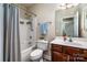 Bathroom featuring shower over tub, vanity, mirror, and updated fixtures at 141 Aberdeen Dr, Troutman, NC 28166
