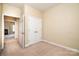 Neutral bedroom featuring a double door closet and doorway to a connecting room at 141 Aberdeen Dr, Troutman, NC 28166