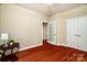 Cozy bedroom with hardwood floors, a ceiling fan, closet space, and a window for natural light at 141 Aberdeen Dr, Troutman, NC 28166