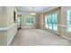 Bright dining room featuring large windows and neutral tones, perfect for entertaining at 141 Aberdeen Dr, Troutman, NC 28166