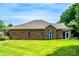 Brick home exterior with well-maintained lawn, screened in porch, and attached carport at 141 Aberdeen Dr, Troutman, NC 28166