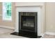 Elegant fireplace with a decorative mantle and dark stone surround, adding warmth to the room at 141 Aberdeen Dr, Troutman, NC 28166