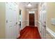 Inviting foyer with hardwood floors, white doors, and trim leading into other parts of the home at 141 Aberdeen Dr, Troutman, NC 28166