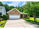 Charming brick home with a two-car garage, manicured lawn, and beautiful landscaping for great curb appeal at 141 Aberdeen Dr, Troutman, NC 28166