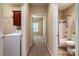 Hallway leading to laundry, bedroom and bathroom featuring tile floor and neutral paint at 141 Aberdeen Dr, Troutman, NC 28166