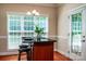 A cozy kitchen island with stools and a granite countertop by a bright window at 141 Aberdeen Dr, Troutman, NC 28166