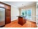 Charming kitchen island with wooden cabinets and an overhead light fixture by a window at 141 Aberdeen Dr, Troutman, NC 28166
