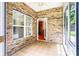 Charming sunroom with brick walls and a ceiling fan, offering a relaxing indoor-outdoor space at 141 Aberdeen Dr, Troutman, NC 28166