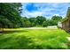Expansive grassy lawn leads to mature trees and greenery at 141 Aberdeen Dr, Troutman, NC 28166