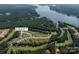 Aerial view of a lakeside community surrounded by lush greenery and a golf course at 171 Old Harbor Dr, Mount Gilead, NC 27306