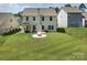 Lush backyard featuring a fire pit and covered patio, perfect for relaxation and entertaining guests at 171 Old Harbor Dr, Mount Gilead, NC 27306