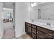 Bathroom with double sink vanity, dark wood cabinets, and view to the bedroom for convenience at 171 Old Harbor Dr, Mount Gilead, NC 27306