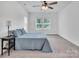 A bedroom features neutral-toned carpet, a ceiling fan, and plenty of light at 171 Old Harbor Dr, Mount Gilead, NC 27306