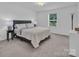 A primary bedroom is well-lit with neutral-toned carpet and furniture at 171 Old Harbor Dr, Mount Gilead, NC 27306
