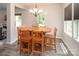 Cozy dining room with an octagonal wood table, six chairs, chandelier, and ample natural light at 171 Old Harbor Dr, Mount Gilead, NC 27306