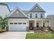 Charming two-story home with a two-car garage, well-manicured lawn, and inviting front porch at 171 Old Harbor Dr, Mount Gilead, NC 27306
