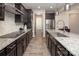 Modern kitchen featuring dark cabinetry, granite countertops, stainless steel appliances, and stylish lighting at 171 Old Harbor Dr, Mount Gilead, NC 27306