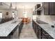 Open-concept kitchen with granite countertops, stainless steel appliances, and a view of the living area at 171 Old Harbor Dr, Mount Gilead, NC 27306