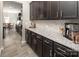 Spacious kitchen showcasing dark cabinets, granite countertops, subway tile backsplash, and stainless steel appliances at 171 Old Harbor Dr, Mount Gilead, NC 27306