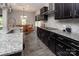 Well-equipped kitchen with granite countertops, dark cabinets, and stainless steel appliances at 171 Old Harbor Dr, Mount Gilead, NC 27306