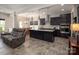 Open concept kitchen with dark cabinets, granite island, stainless steel appliances, and adjacent living space at 171 Old Harbor Dr, Mount Gilead, NC 27306