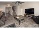 Bright and open living room featuring a fireplace, television, comfortable seating, and a view of the staircase at 171 Old Harbor Dr, Mount Gilead, NC 27306