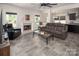 Inviting living room with a fireplace, leather seating, modern decor, and open layout to dining area at 171 Old Harbor Dr, Mount Gilead, NC 27306