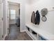 The mud room has coat hooks, a bench, and a view into the laundry room at 171 Old Harbor Dr, Mount Gilead, NC 27306