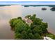 Aerial view of lakefront home on an island with lush trees at 173 Rehoboth Ln, Mooresville, NC 28117