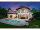 Beautiful backyard with a pristine pool and a curved wall of windows offering panoramic views at 173 Rehoboth Ln, Mooresville, NC 28117